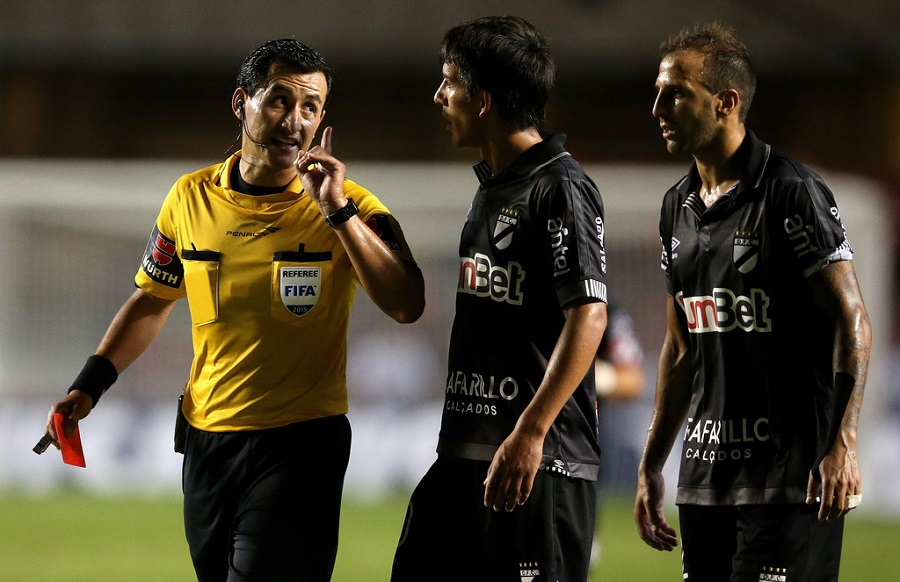 Danubio players complain to the referee that Sao Paulo "won't share the ball! It's not fair!" (Zimbio)